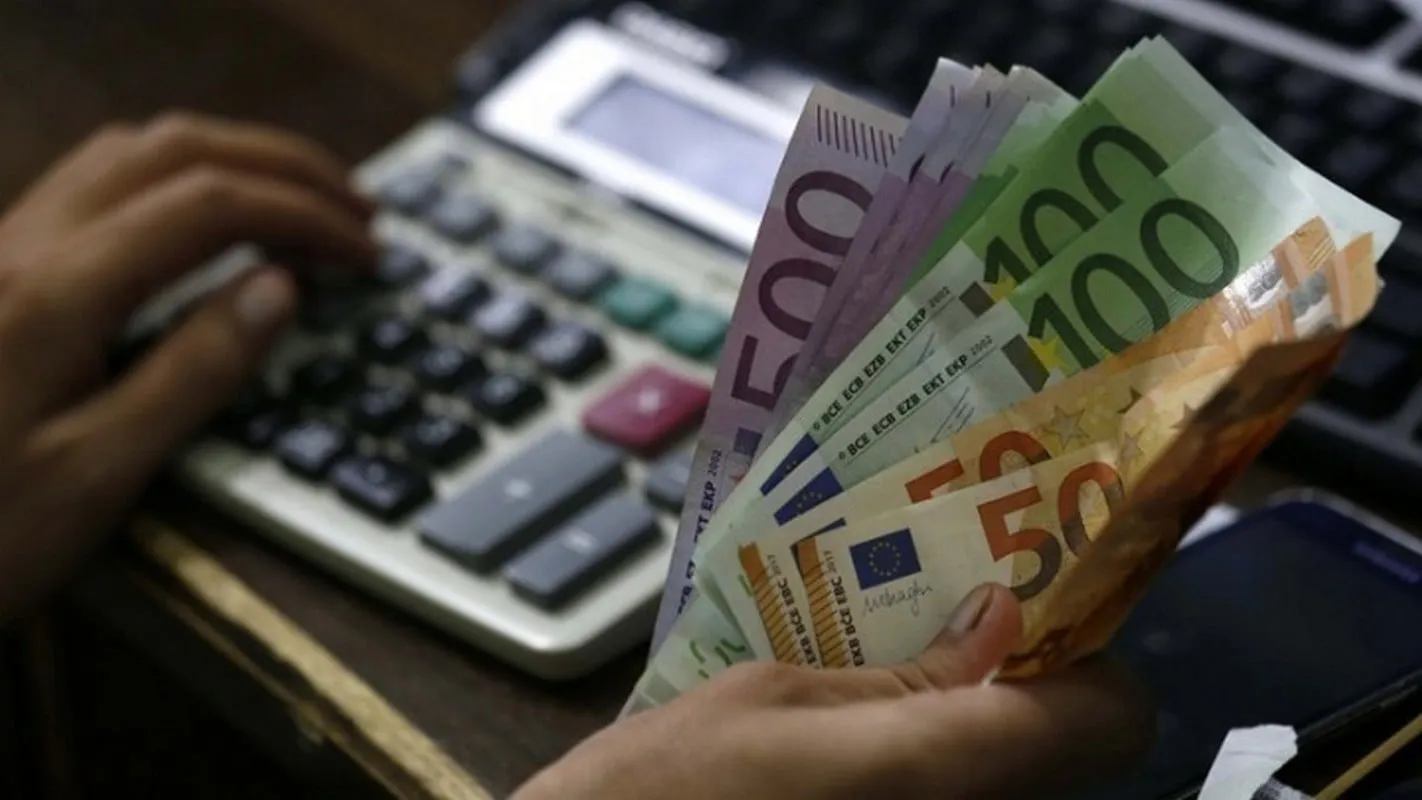 Έγγραφα ρύθμισης οφειλών και αριθμοί σε οθόνη υπολογιστή
