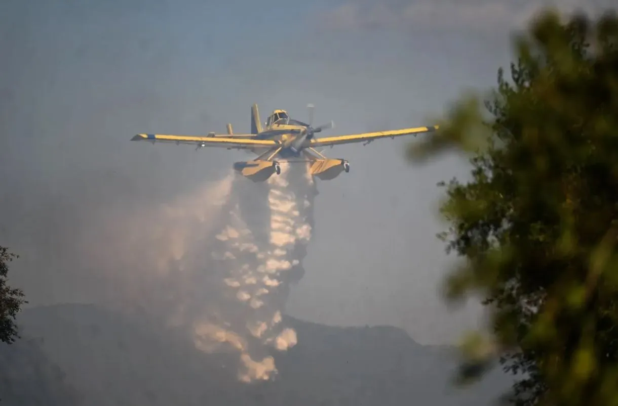 Πυροσβεστικό αεροσκάφος ρίχνει νερό σε δασική φωτιά